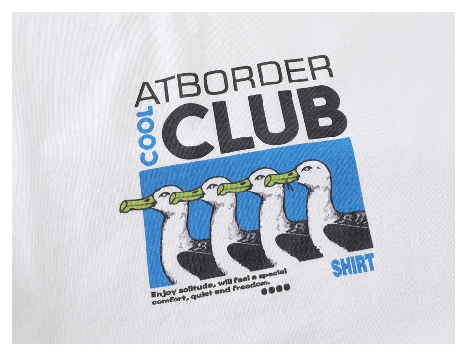 Close-up of a blue, black, and white cartoon graphic with English text printed on a white shirt.