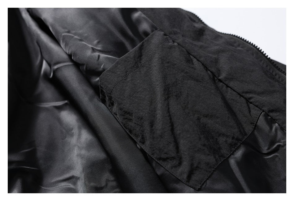 Close-up of the black jacket's interior lining and a fabric pocket.