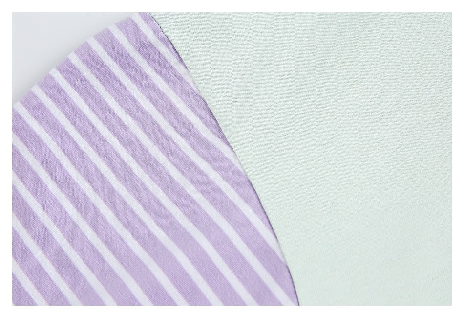 Close-up of pale mint fabric beside a lavender-and-white striped panel.