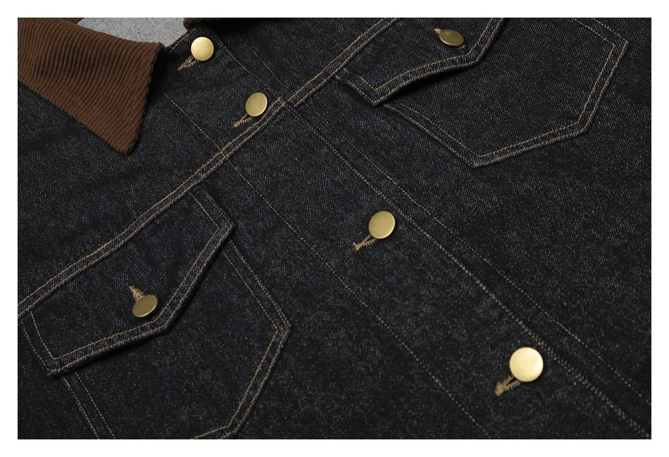 Close-up of the dark denim jacket’s front, showing the brown collar, chest pocket flaps, contrast stitching and brass-tone