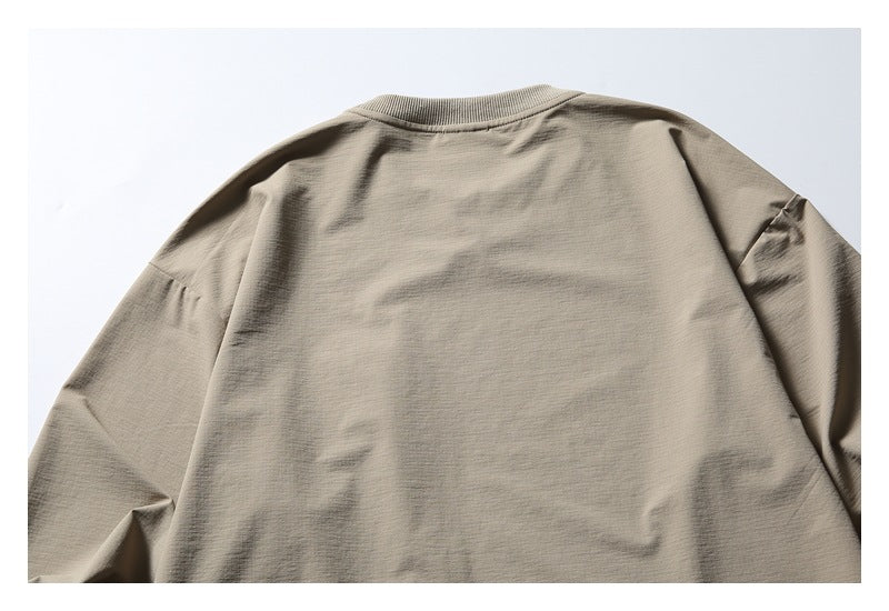Back view of a plain taupe long-sleeve garment with a ribbed crew neckline.