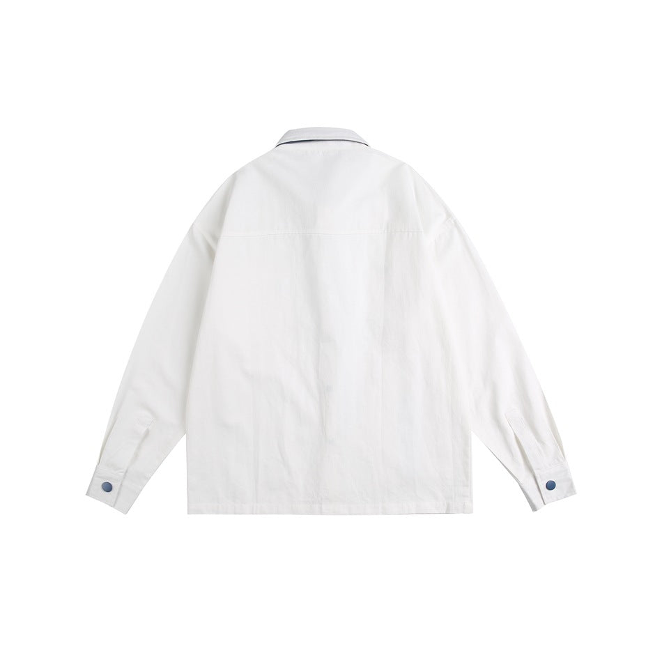 Back view of a white long-sleeved button-up shirt with a yoke seam and blue cuff buttons.