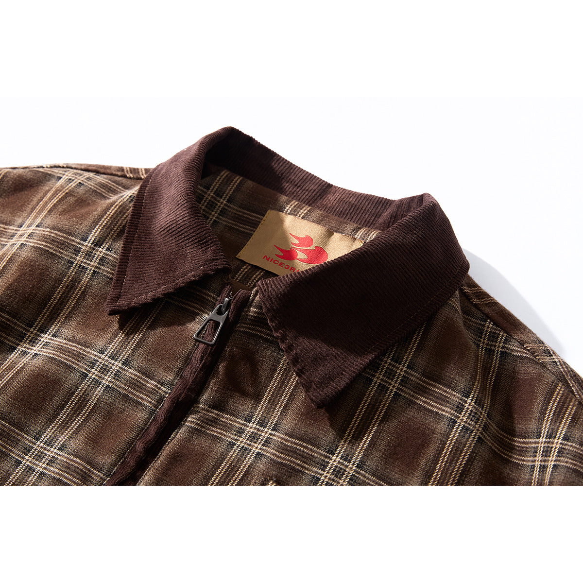 Close-up of a brown plaid jacket's dark corduroy collar, zipper, and sewn neck label.