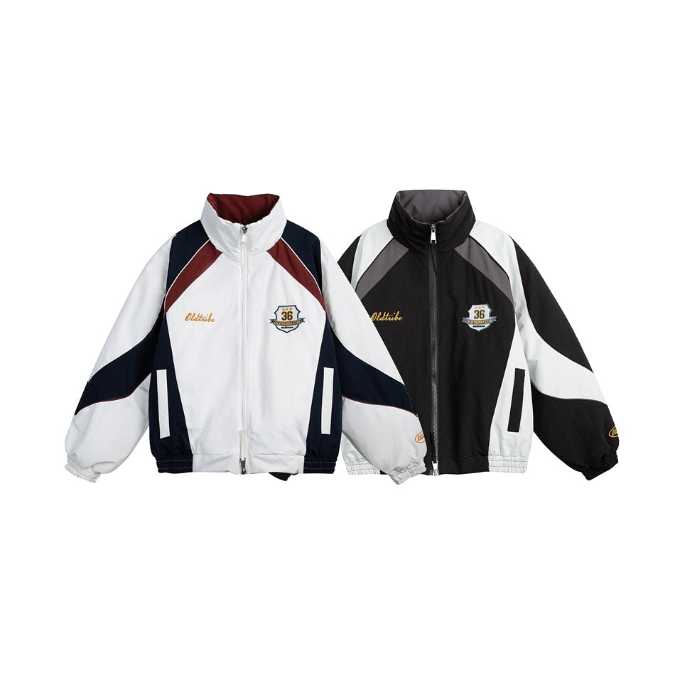 Two front-view colorways of a high-collar zip jacket: white with navy and burgundy panels, and black with gray and white