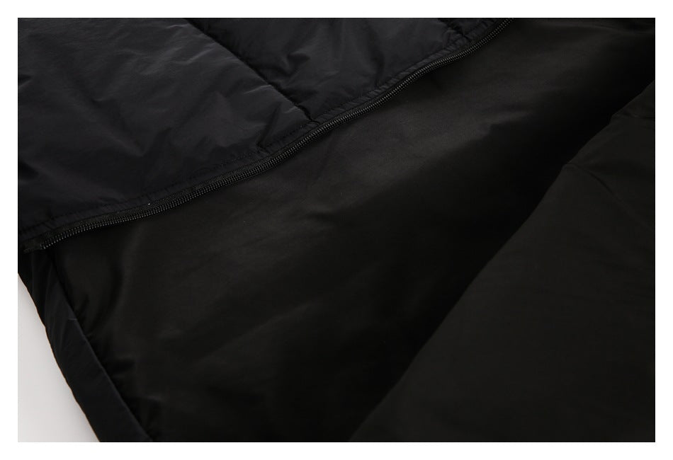 Close-up of a black zipper joining two sections of a black garment.