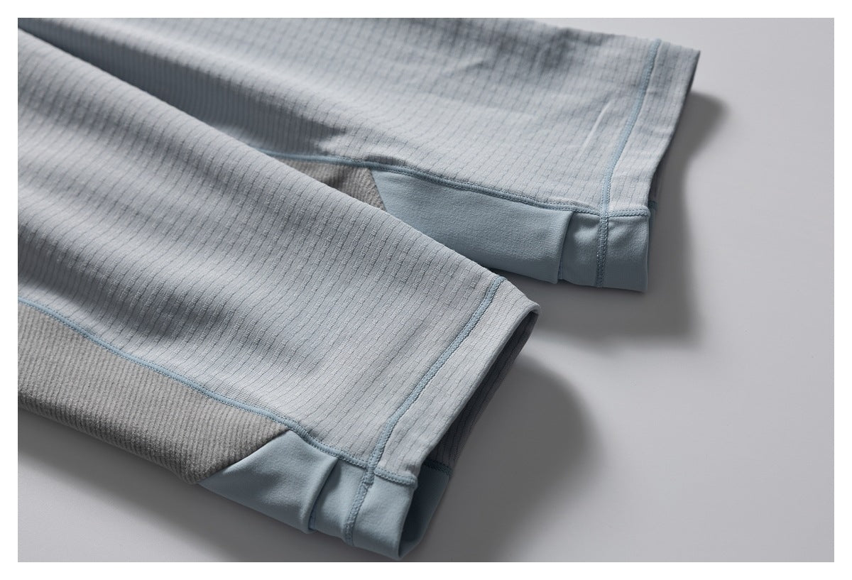 Close-up of the shirt’s sleeve ends, showing gray-blue cuffs, textured fabric, and contrast stitching.