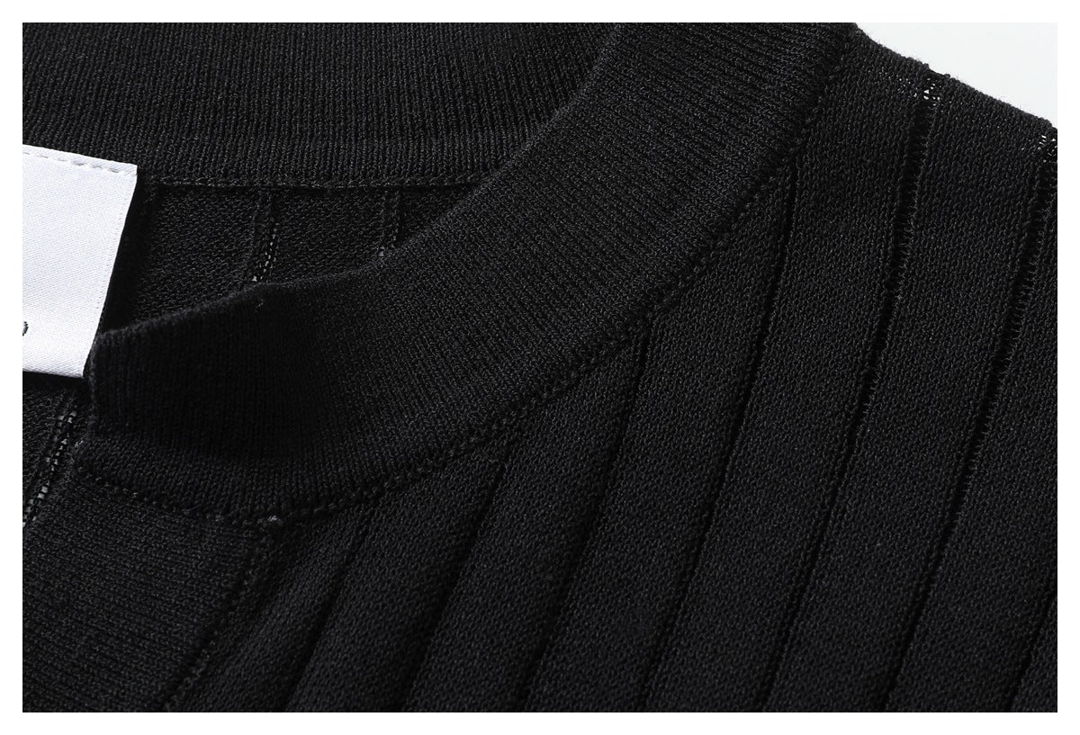 Close-up of the black top's ribbed neckline and shoulder area.
