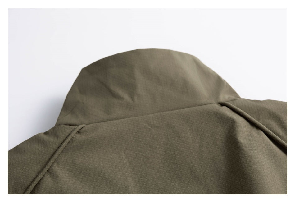 Close-up of the olive jacket’s raised collar and upper back seams.