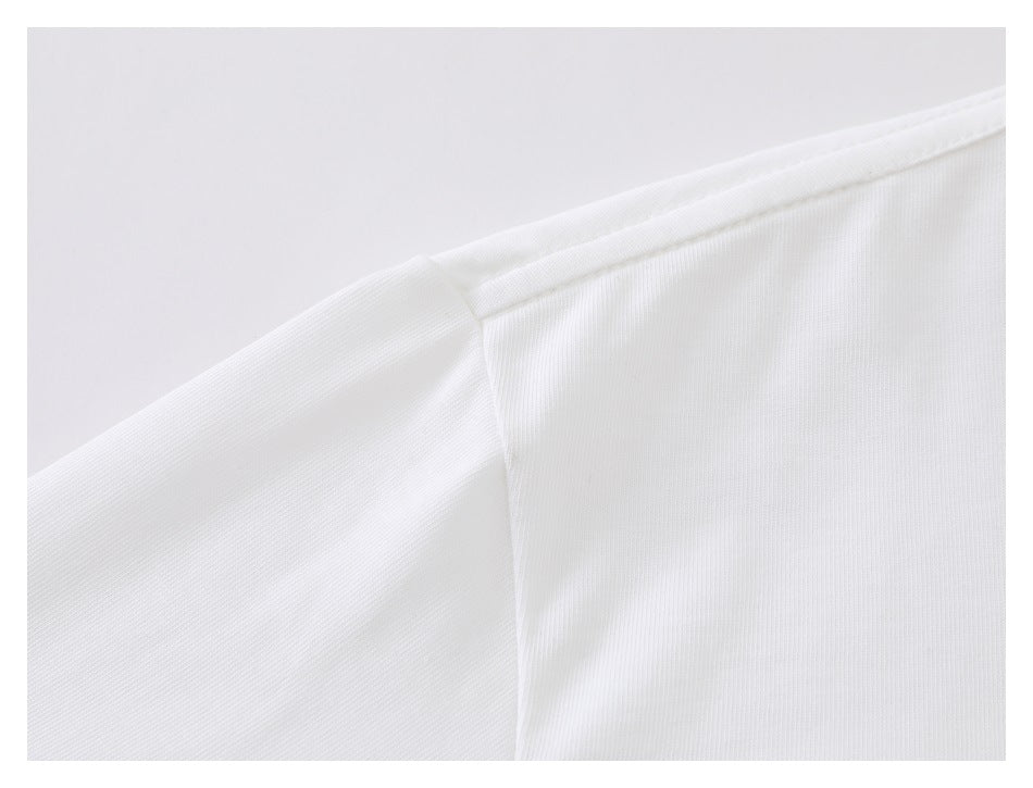 Close-up of the white shirt's shoulder seam and sleeve attachment.