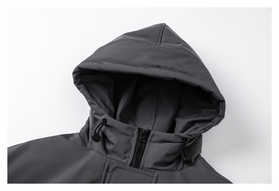 Close-up of the charcoal jacket's hood, drawcords, high collar, and front zipper.