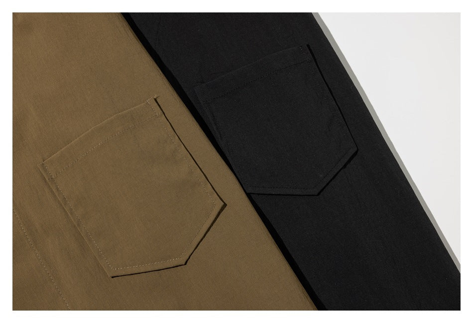 Close-up of angular patch pockets on brown and black garments.