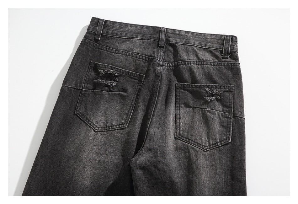 Rear view of charcoal-black jeans with belt loops and two distressed back pockets.