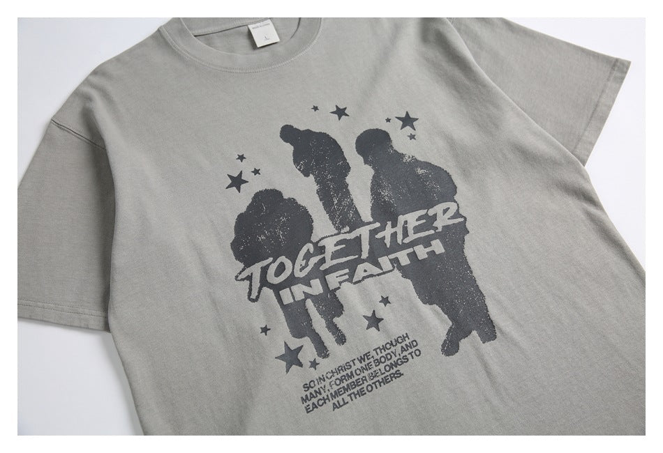 Angled front view of a gray short-sleeve T-shirt with a dark three-figure graphic, stars, and English text.