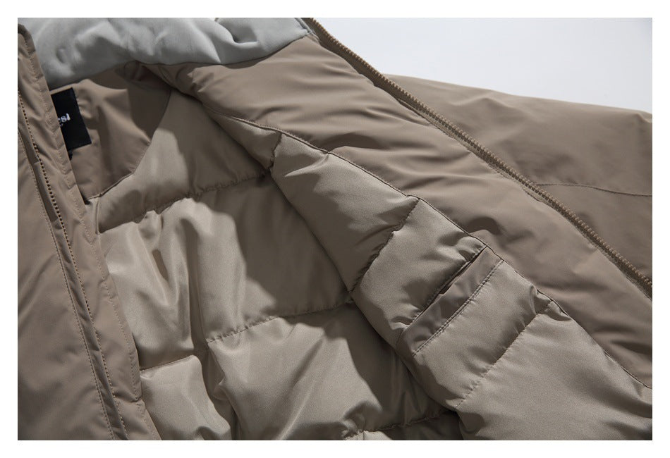 Interior close-up of a taupe padded garment showing the lining, zipper, and a sewn-in black label.