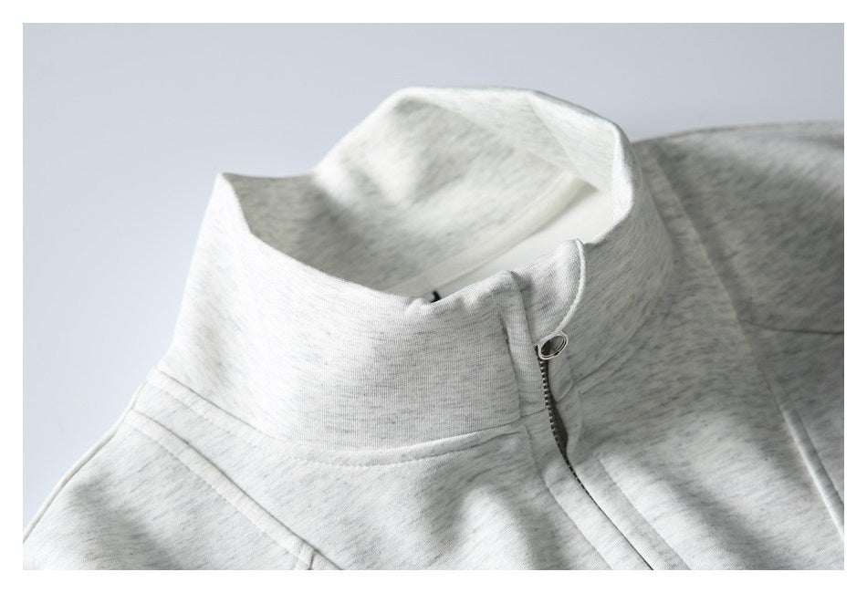 Close-up of the light gray heather sweatshirt's high collar and short zipper.