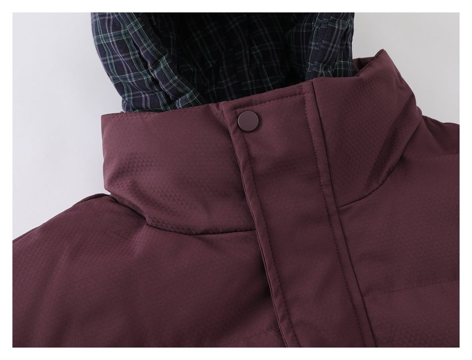 Close-up of a burgundy jacket collar and snap-button storm flap, with plaid hood lining visible.