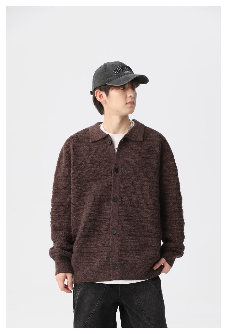 Model wearing a dark brown ribbed button-front cardigan with a collar over a white T-shirt.