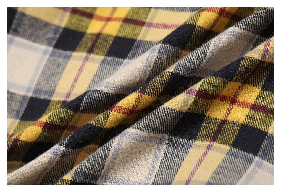 Close-up of the jacket's yellow, cream, gray, and black plaid fabric, showing its woven pattern.
