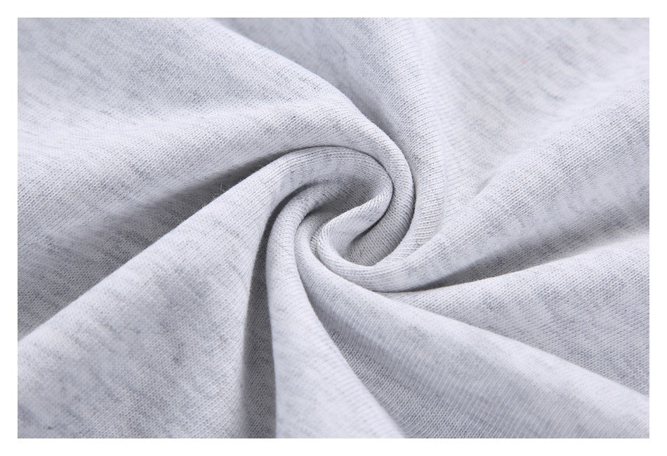 Close-up of light gray heathered shirt fabric twisted into folds.