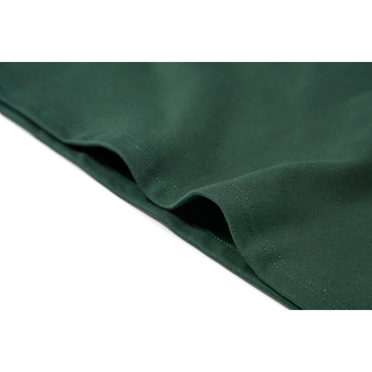 Close-up of the double-stitched hem on a dark green T-shirt.