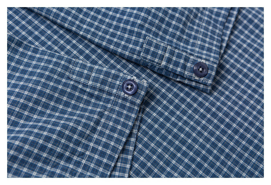Close-up of a blue plaid shirt showing two buttoned cuffs with matching fabric and stitching.