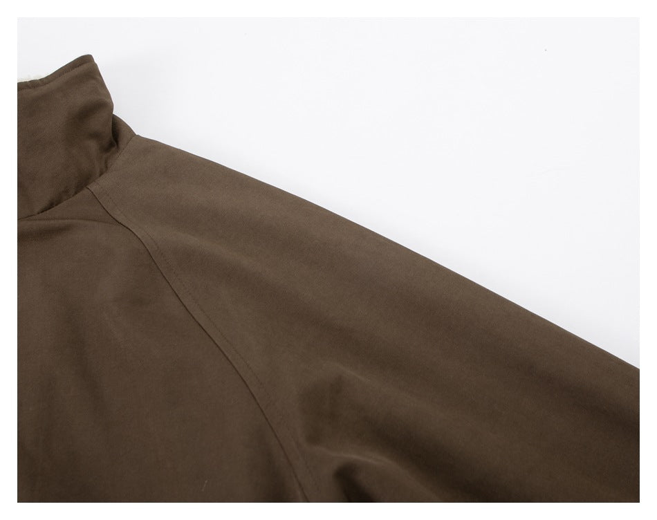 Close-up of the brown jacket's sleeve and curved raglan seam.