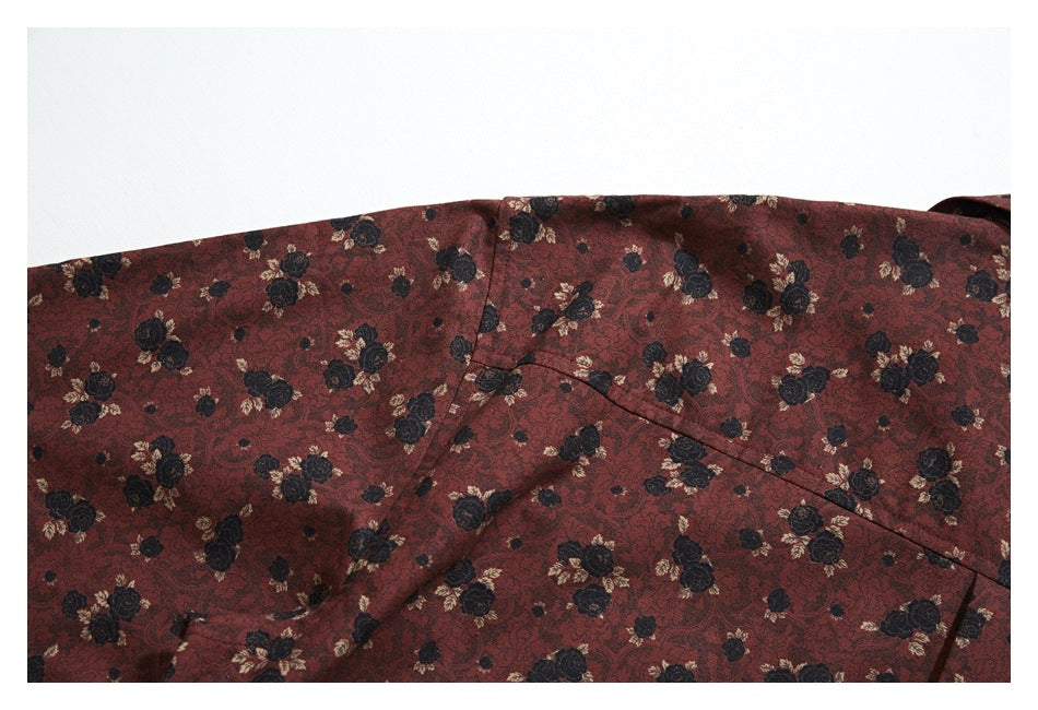 Close-up of a reddish-brown floral garment panel with a diagonal seam and stitched edge.