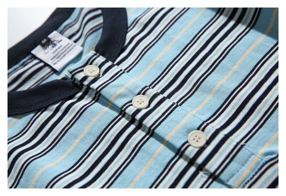 Close-up of the striped shirt's dark collar and three cream buttons on the placket.