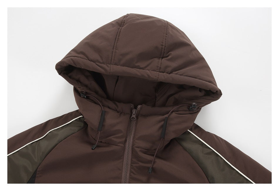 Close view of the brown jacket's hood, front zipper, drawcords, and olive shoulder panels with white piping.