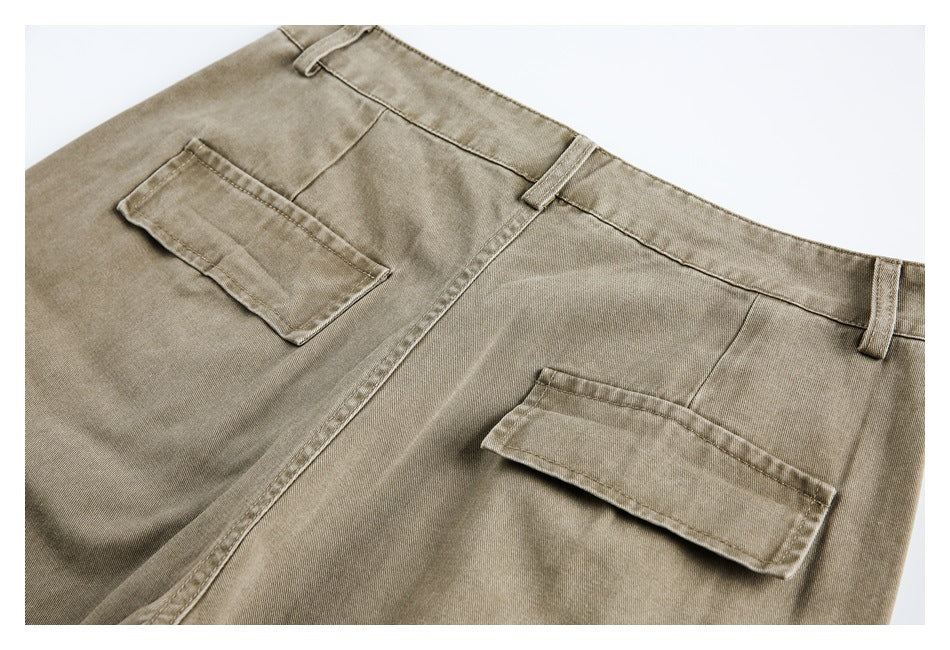 Cropped rear view of khaki trousers with two flap pockets and belt loops.