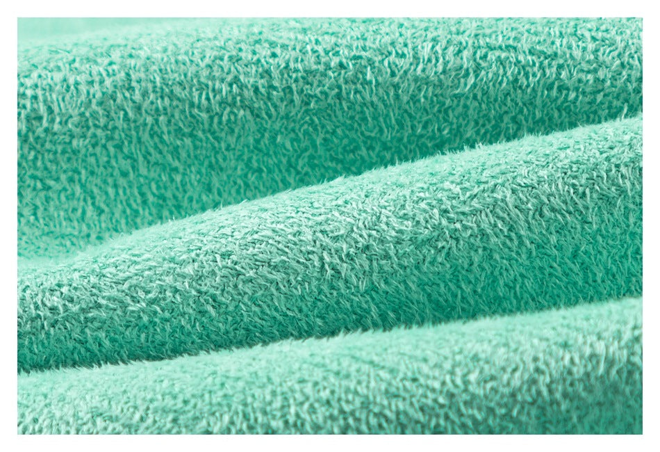 Extreme close-up showing the looped, textured surface of mint-green fabric.