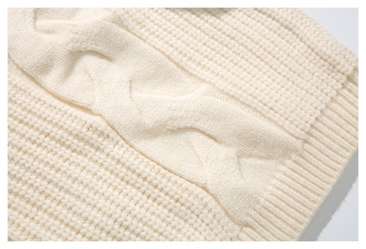 Close-up of cream sweater knit texture beside a ribbed sleeve cuff.
