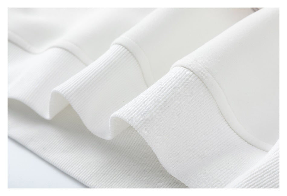 Close-up of a white garment's wide ribbed edge folded into soft waves.