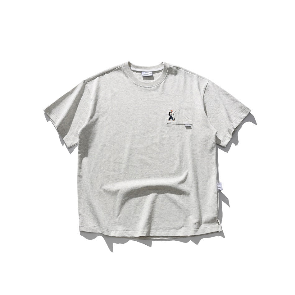 Light heathered gray short-sleeve crew-neck T-shirt with embroidered hiker patch on the left chest, flat lay