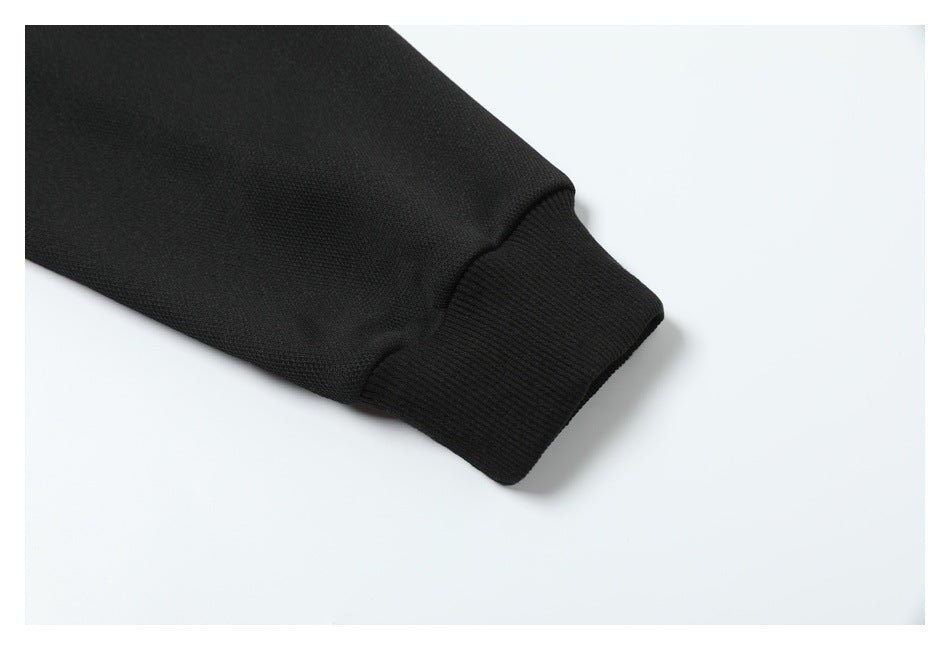 Close-up of a black sleeve ending in a wide ribbed cuff.