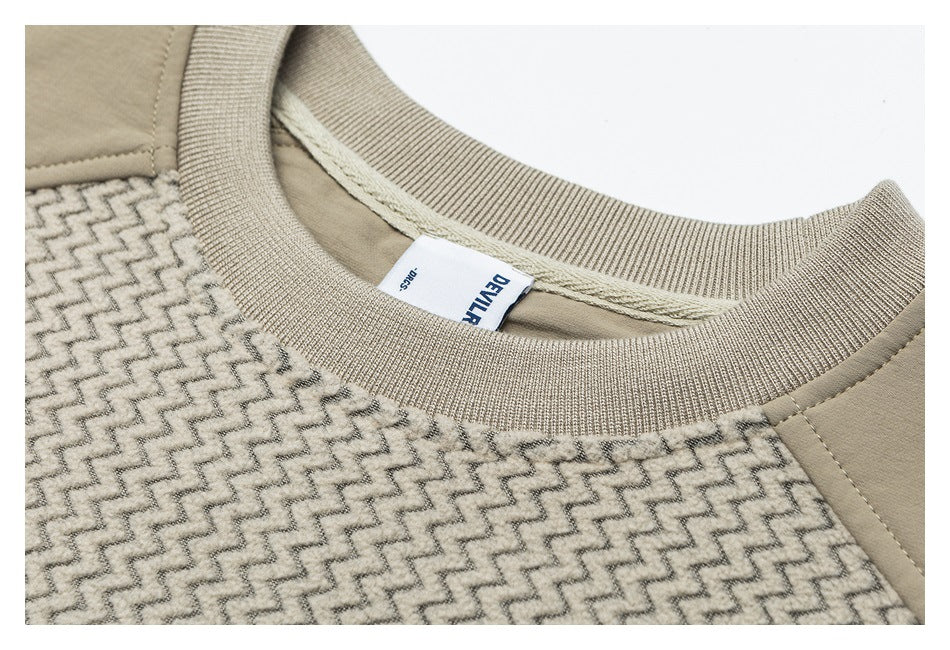 Close-up of a beige ribbed neckline, zigzag-patterned fabric, and sewn brand label.