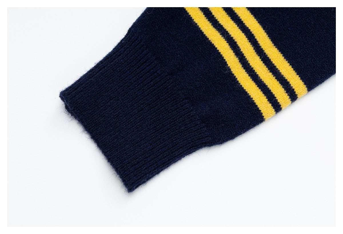 Close-up of a navy ribbed sleeve cuff with three mustard-yellow stripes.