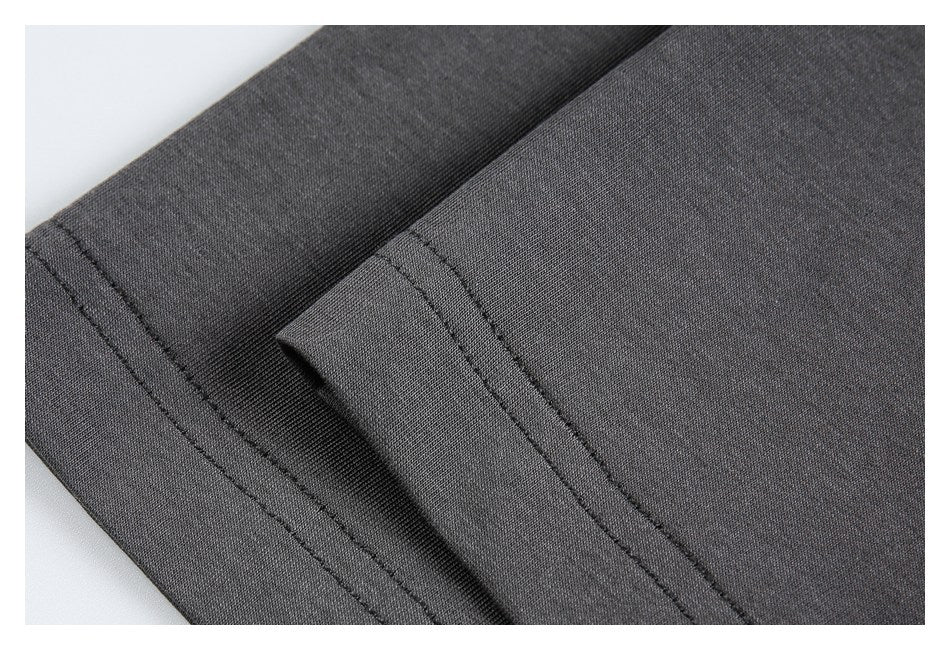 Close-up of folded charcoal fabric with parallel rows of stitching along the edge.