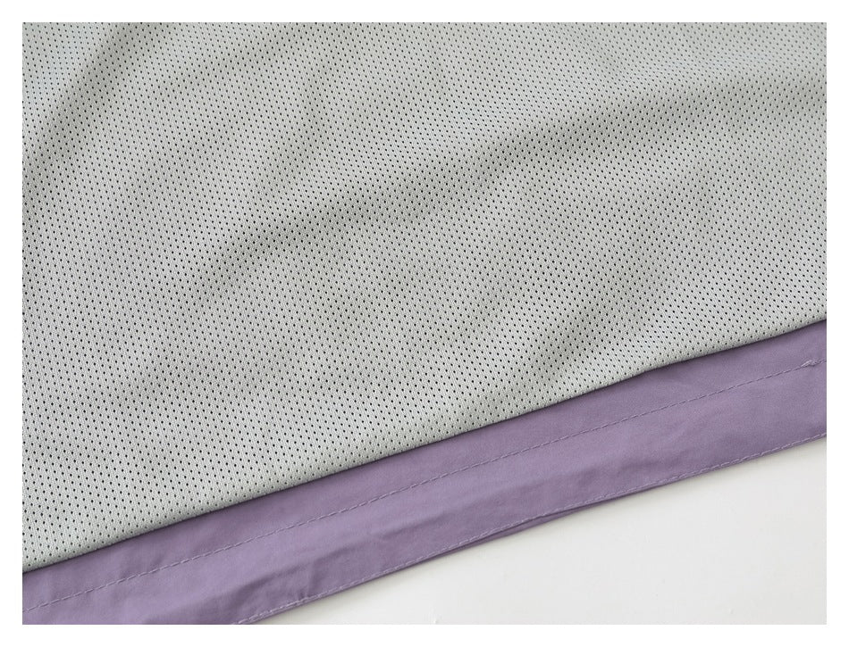 Close-up of cream perforated fabric beside a lavender garment panel with a stitched edge.