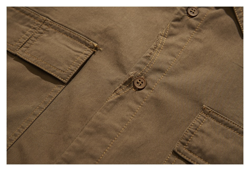 Close-up of a brown shirt front with buttons, a placket, and partial flap pockets.