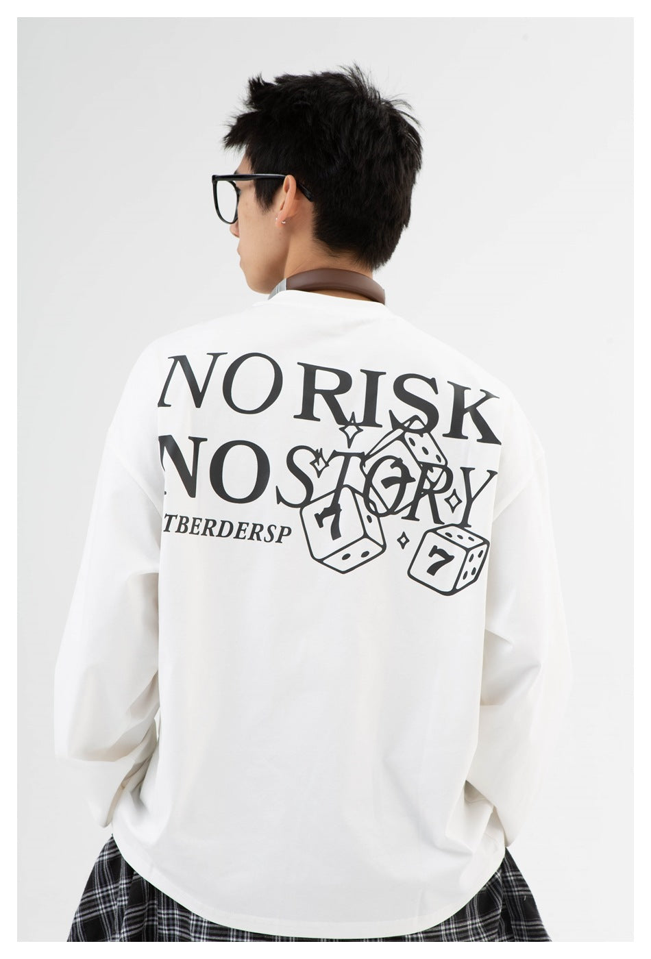 Model wearing a white long-sleeve shirt with a large black dice graphic and lettering across the back.