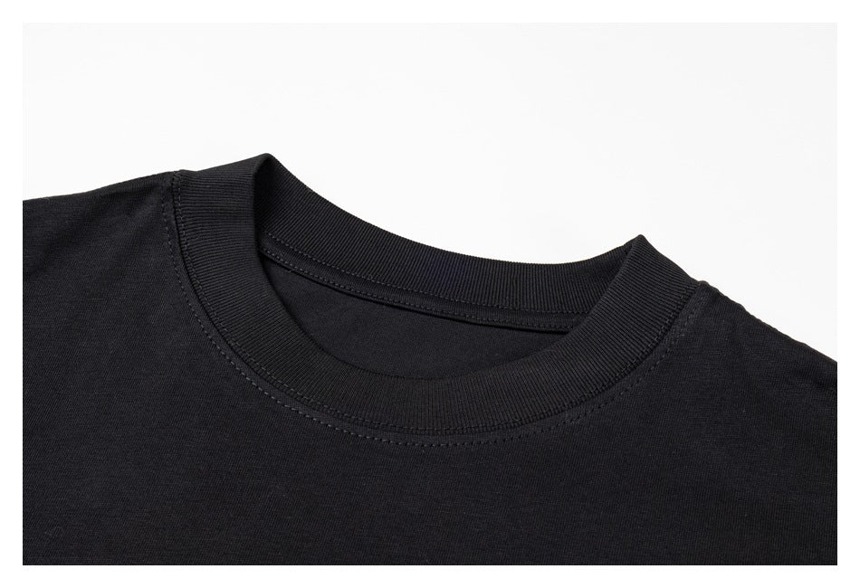 Close-up of a black T-shirt's ribbed crew neck and shoulder seams.
