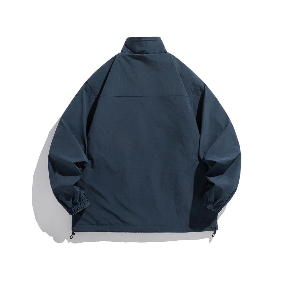 Back view of a dark navy pullover jacket with a high collar, elastic cuffs, and adjustable hem toggles.