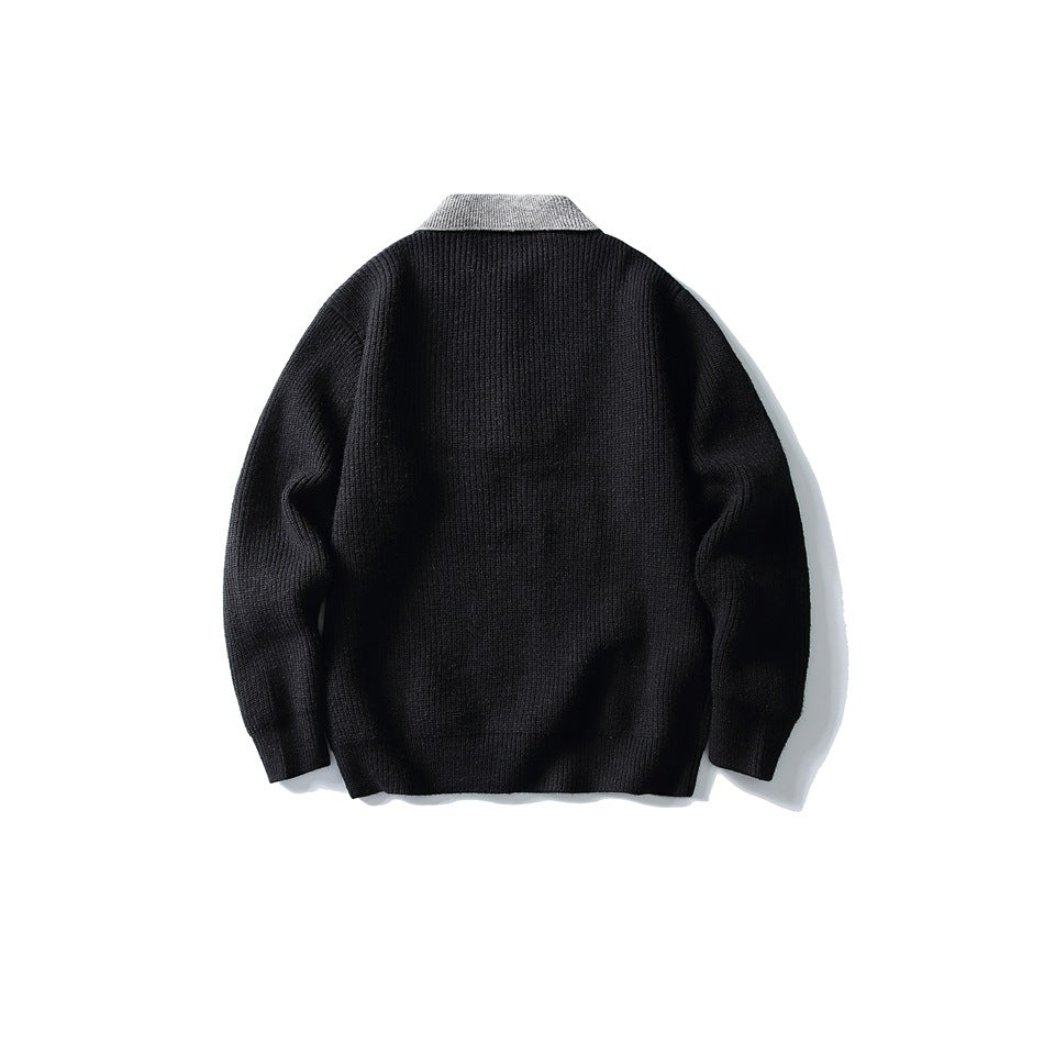 Back view of a black long-sleeved knit sweater with a contrasting gray ribbed collar.