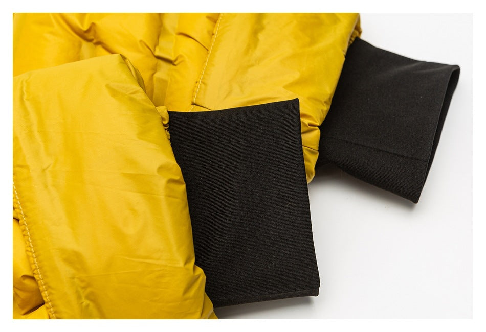 Close-up of mustard-yellow jacket sleeves with wide black ribbed cuffs.