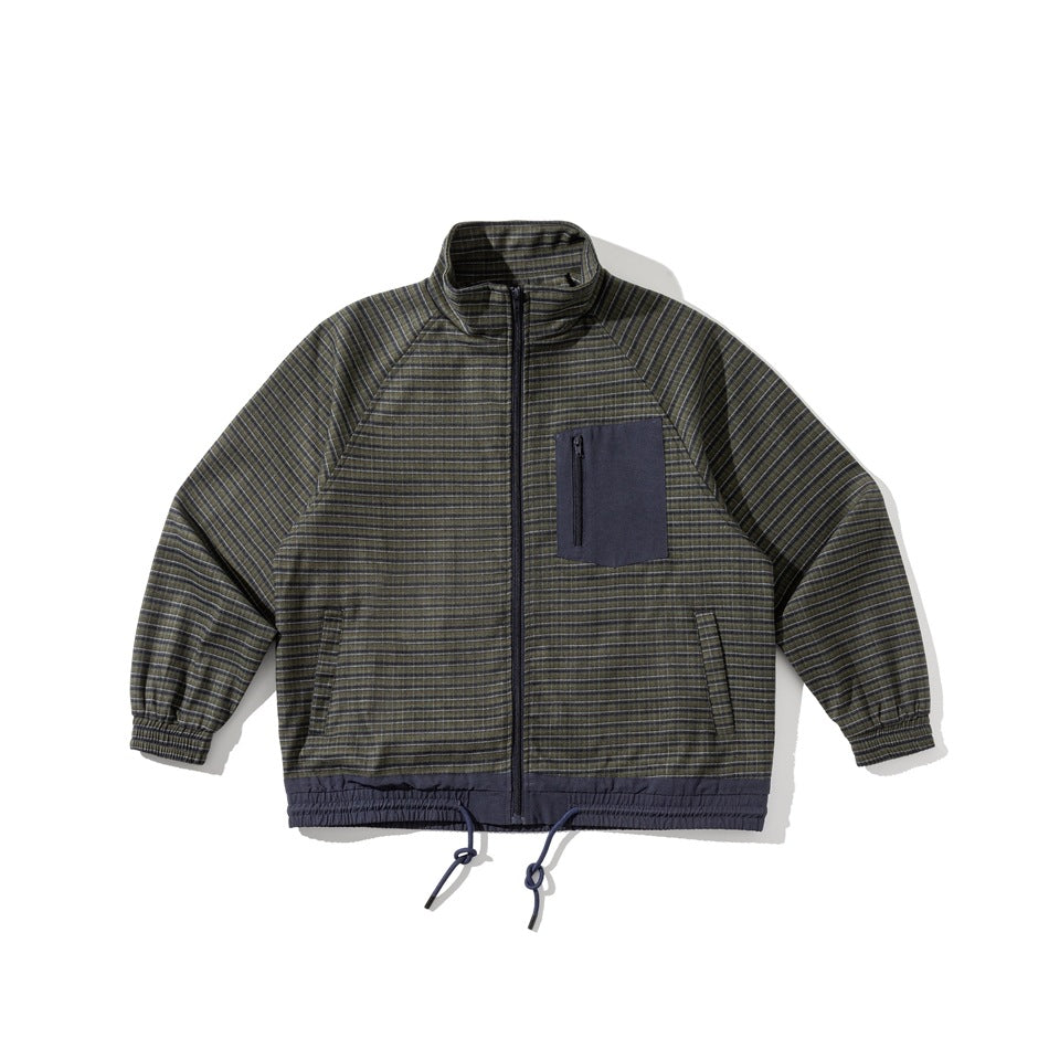 Green and navy plaid zip-front stand-collar jacket flat lay with navy chest pocket and drawstring hem