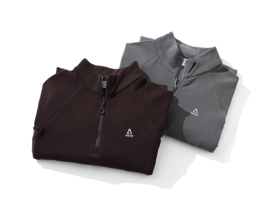 Two folded quarter-zip pullovers, one dark brown and one gray, displayed together on a white background.