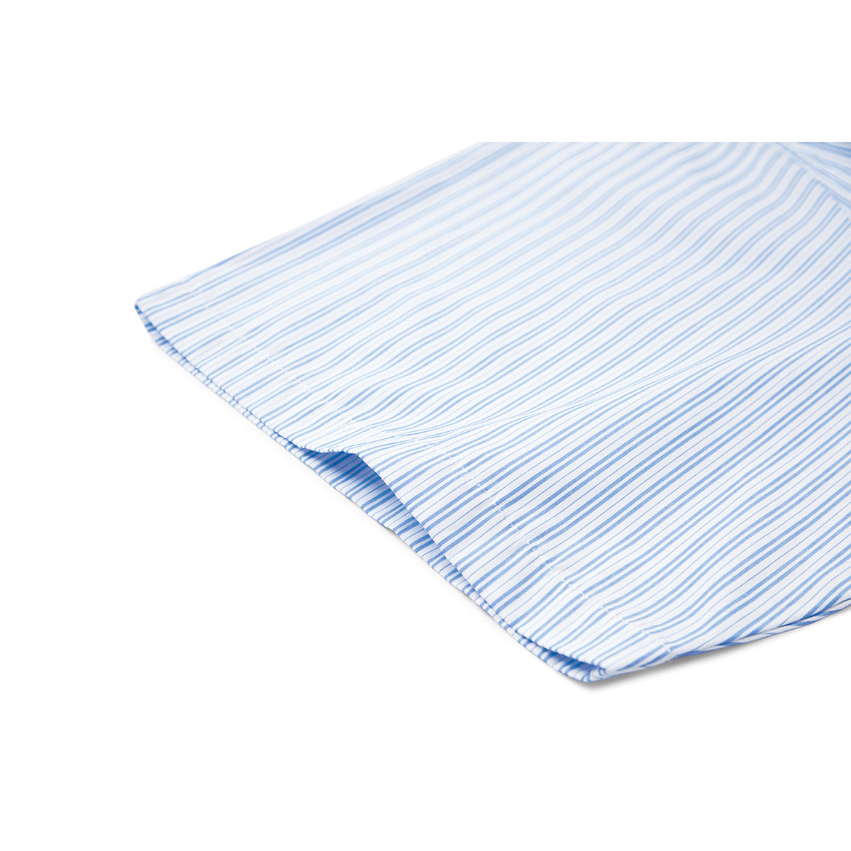 Close-up of the curved hem of a white shirt with fine blue stripes.
