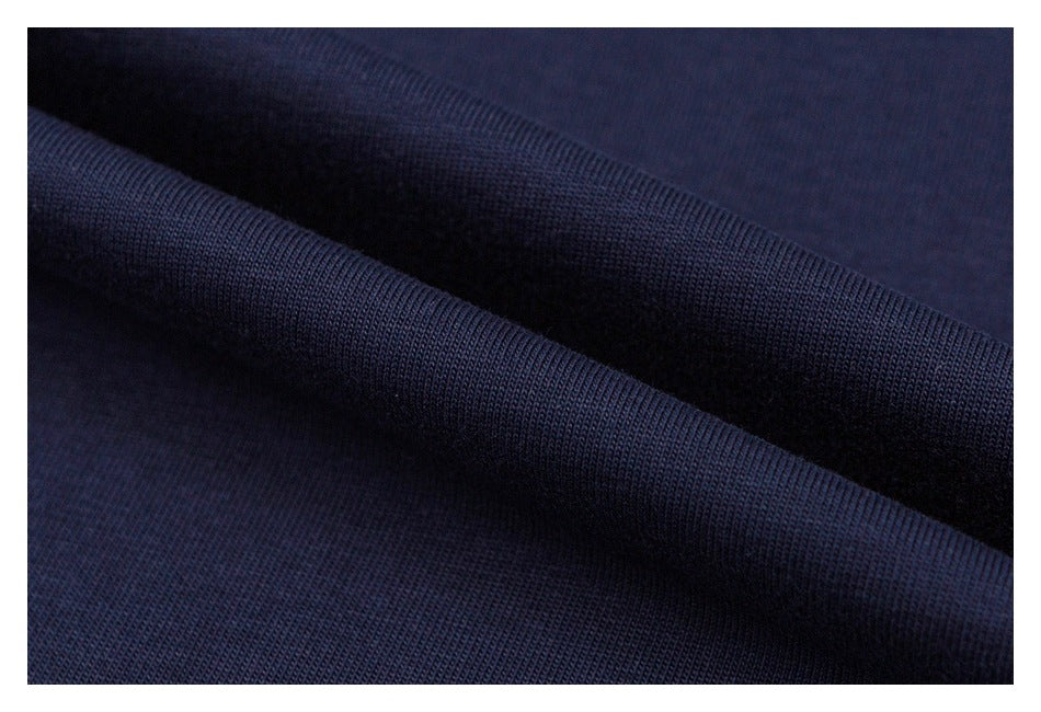 Close-up of folded navy fabric showing its surface and knit texture.
