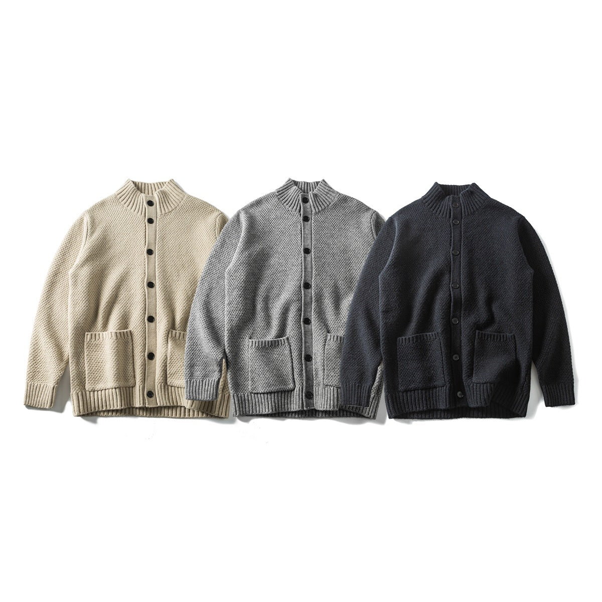 Three front views of button-front knit cardigans with stand collars and patch pockets in beige, gray, and black.